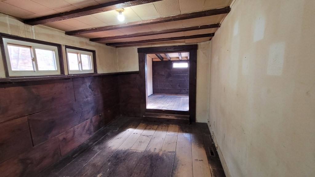 136 Main Road Westfield, MA 01085 - Photo 8 of 13 a view of a hallway with wooden floor and a living room