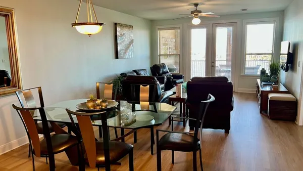 a view of a dining room with furniture wooden floor and chandelier