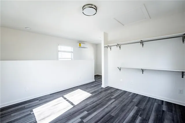 a view of a room with wooden floor and white walls