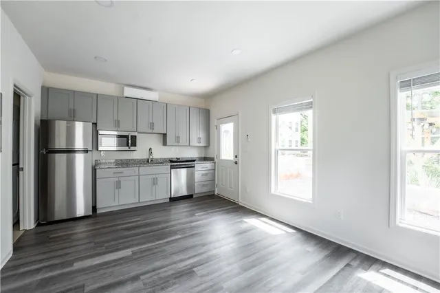 a kitchen with stainless steel appliances granite countertop a refrigerator sink and cabinets