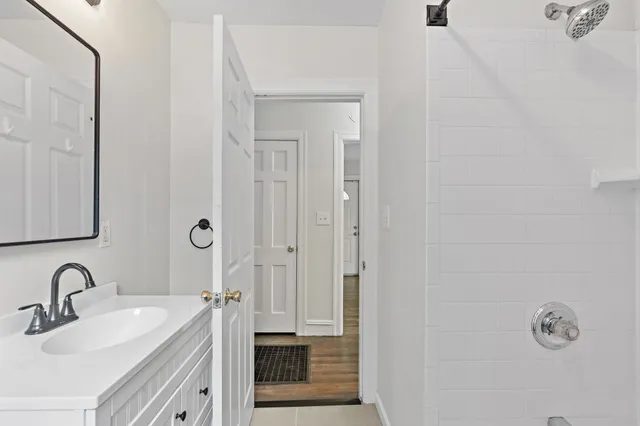 a bathroom with a double vanity sink and a mirror