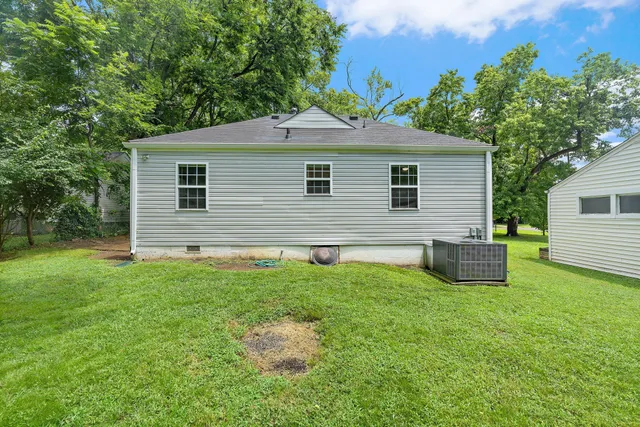 a backyard of a house with table and chairs