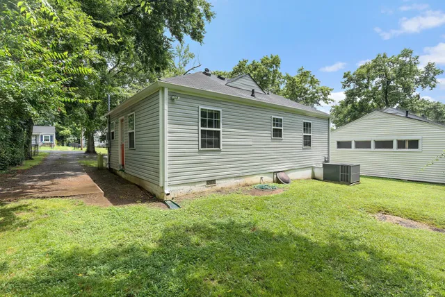 a backyard of a house with table and chairs