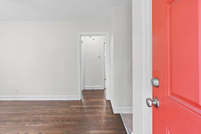 a view of a room with wooden floor and shower