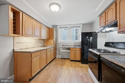 a kitchen with a stove a sink and a refrigerator