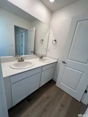 a bathroom with a double vanity sink and mirror