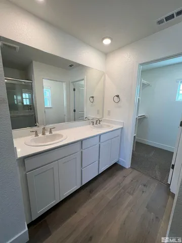 a bathroom with a double vanity sink and mirror