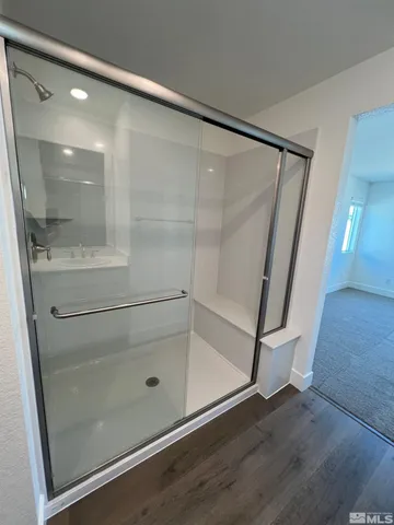 a bathroom with a glass shower door