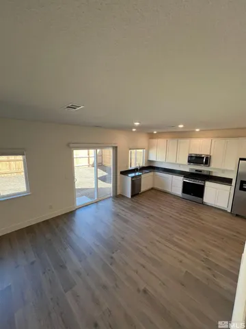 a view of kitchen with cabinets and wooden floor