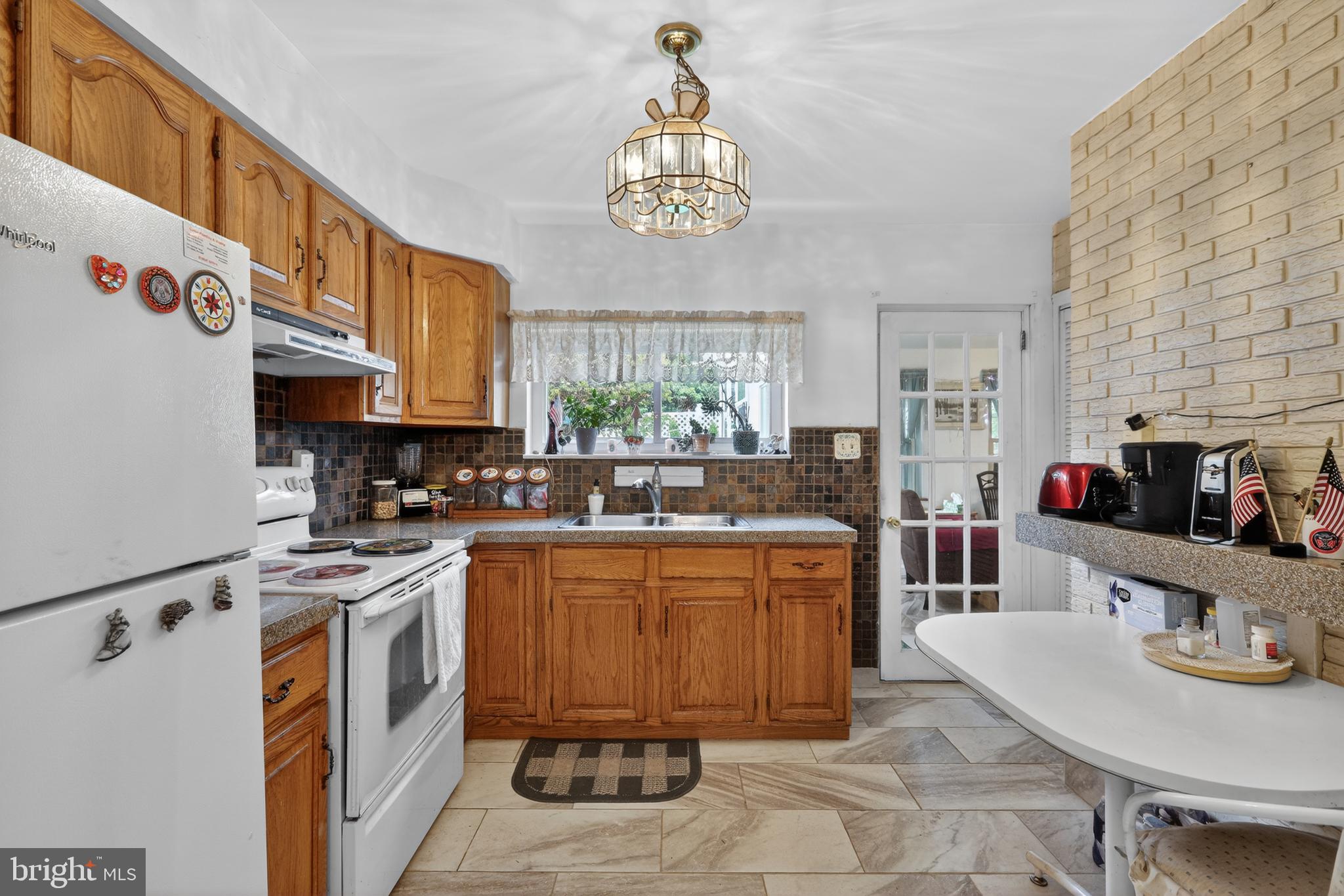 1424 Burmont Road Havertown, PA 19083 - Photo 12 of 37 a kitchen with stainless steel appliances a stove a sink dishwasher and cabinets