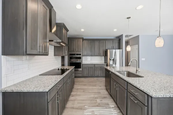 a kitchen with a sink appliances and cabinets