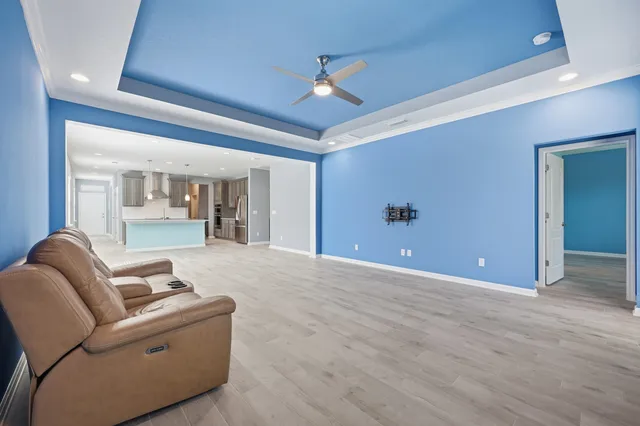 a living room with furniture and a ceiling fan