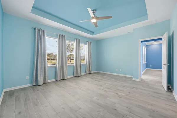 a bathroom with a granite countertop sink a large mirror and shower