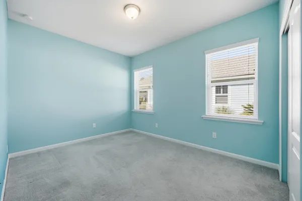 a living room with couch and a floor to ceiling window