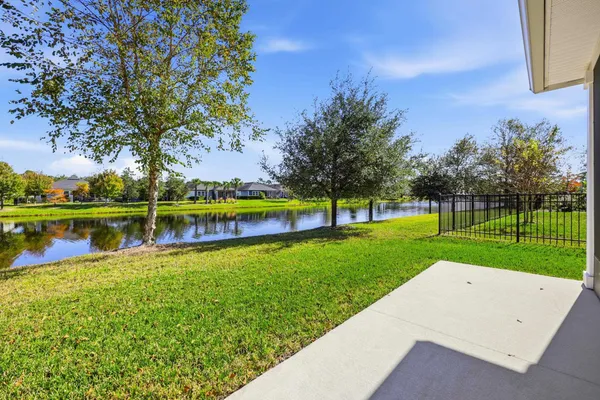 a aerial view of a house with swimming pool and lake view