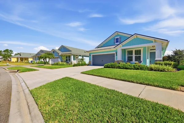 an aerial view of residential houses with outdoor space