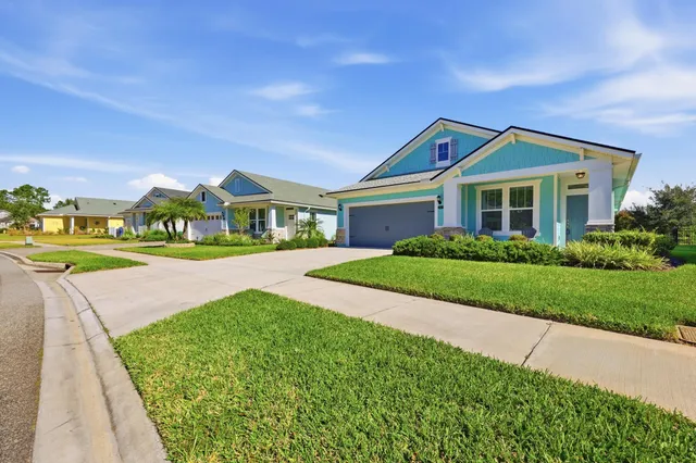 a aerial view of a house with swimming pool and lake view