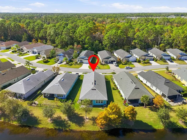 an aerial view of residential houses with outdoor space and swimming pool