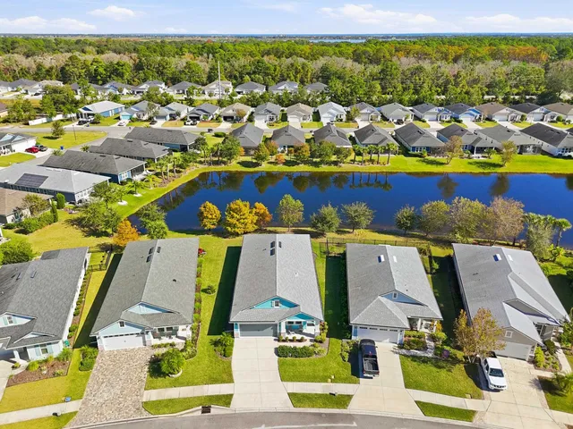 an aerial view of residential houses with outdoor space