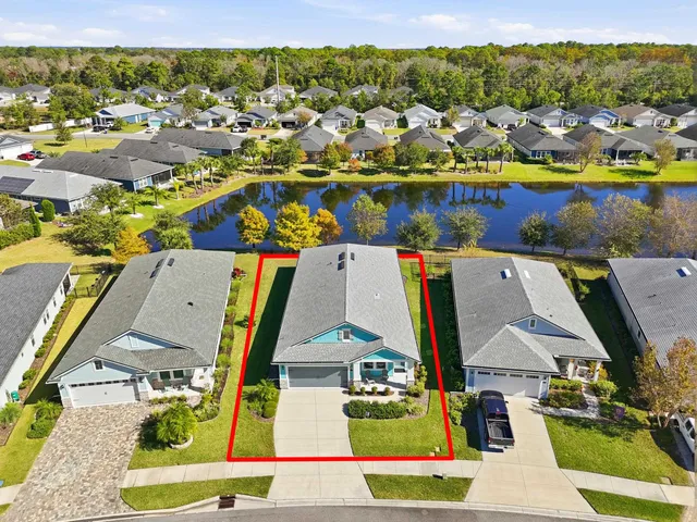 an aerial view of a house with a yard