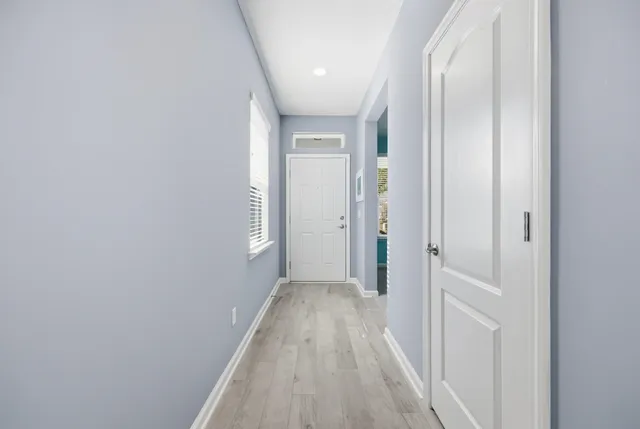 a view of a hallway with wooden floor