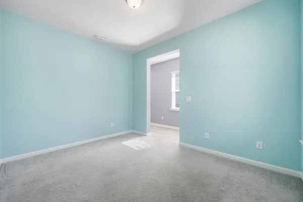 a kitchen with kitchen island granite countertop wooden cabinets and white appliances
