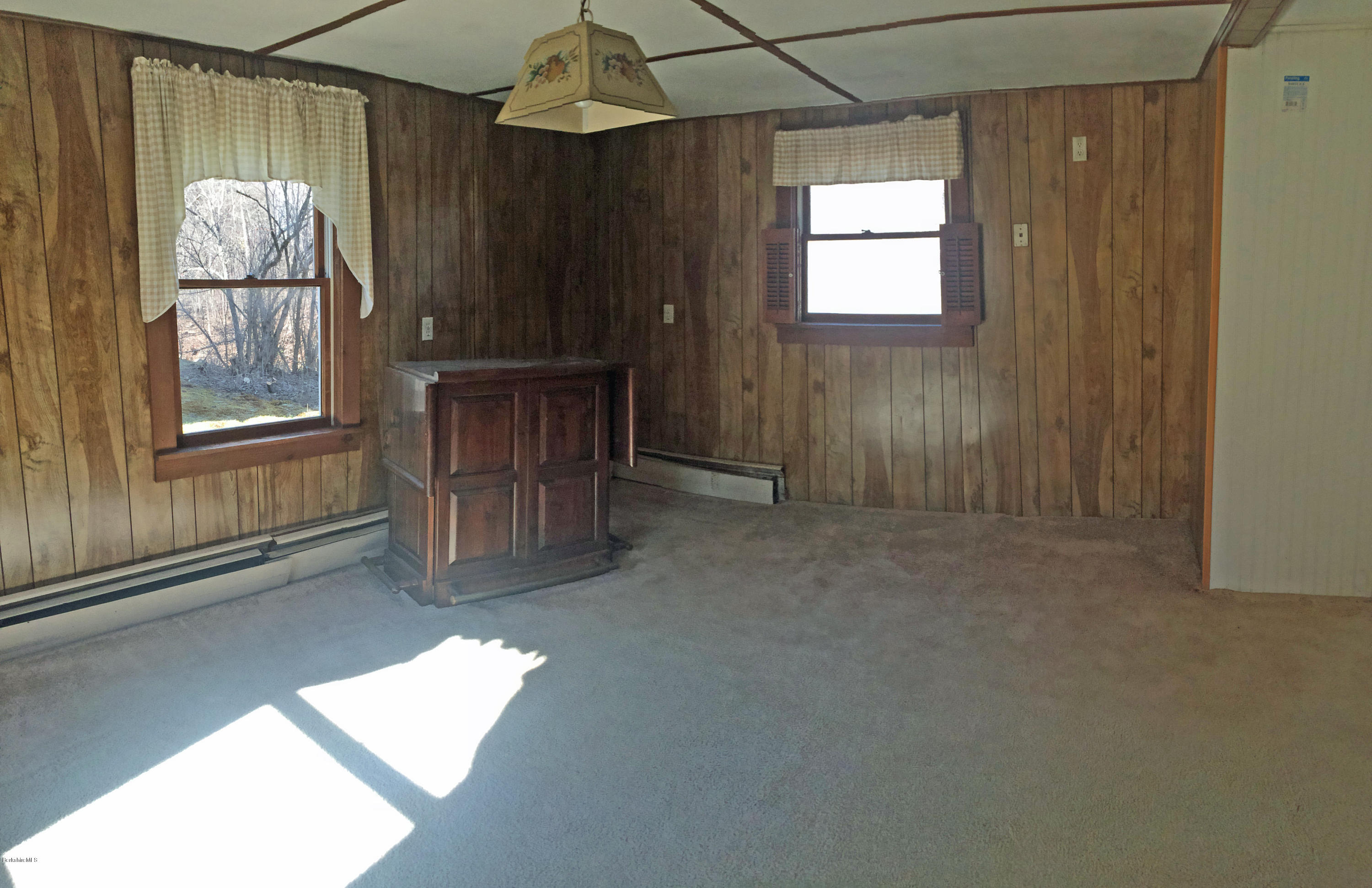 55 Sandisfield Road Sandisfield, MA 01255 - Photo 14 of 20 an empty room with windows and cabinet