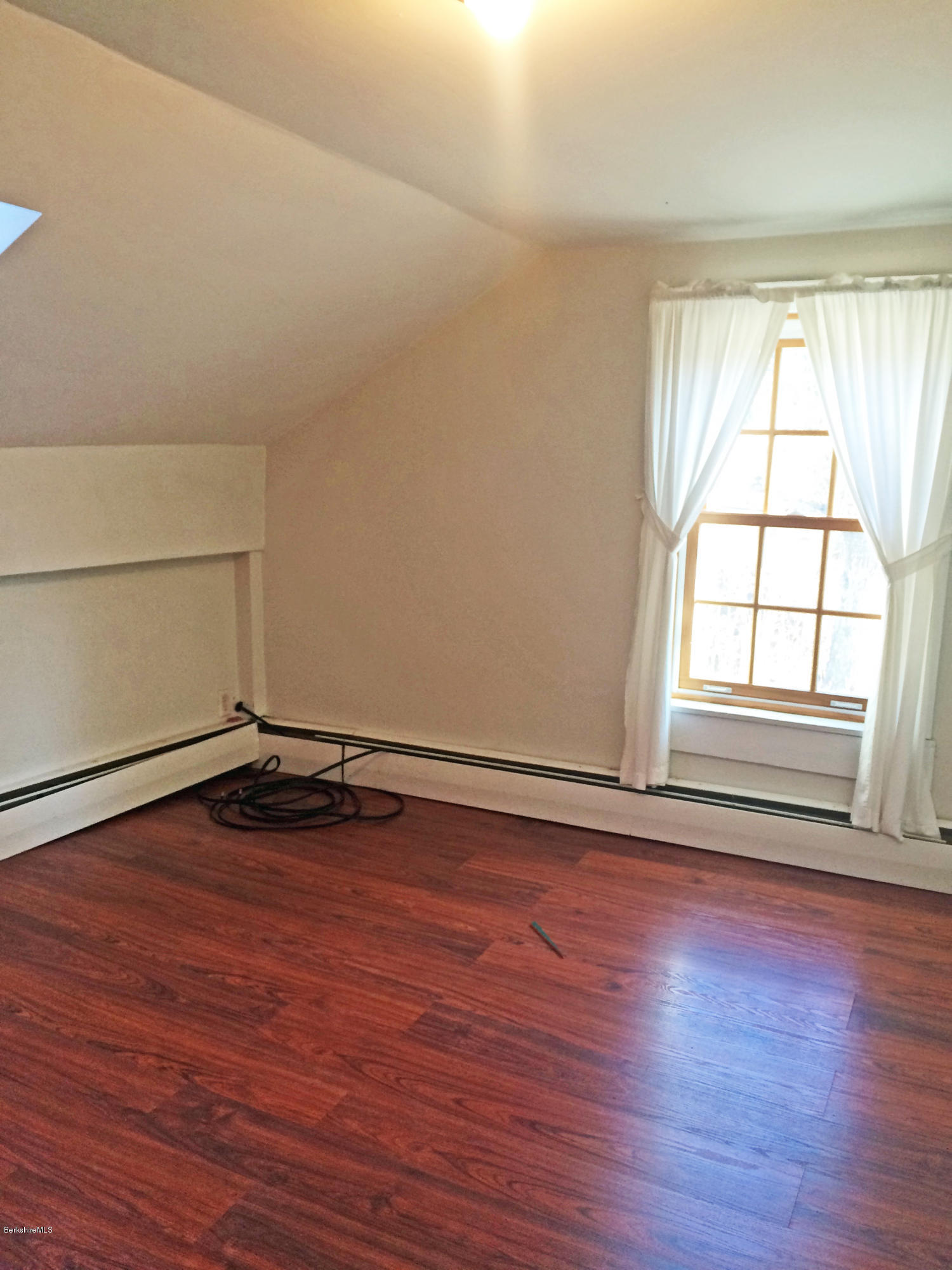 55 Sandisfield Road Sandisfield, MA 01255 - Photo 18 of 20 an empty room with wooden floor and windows