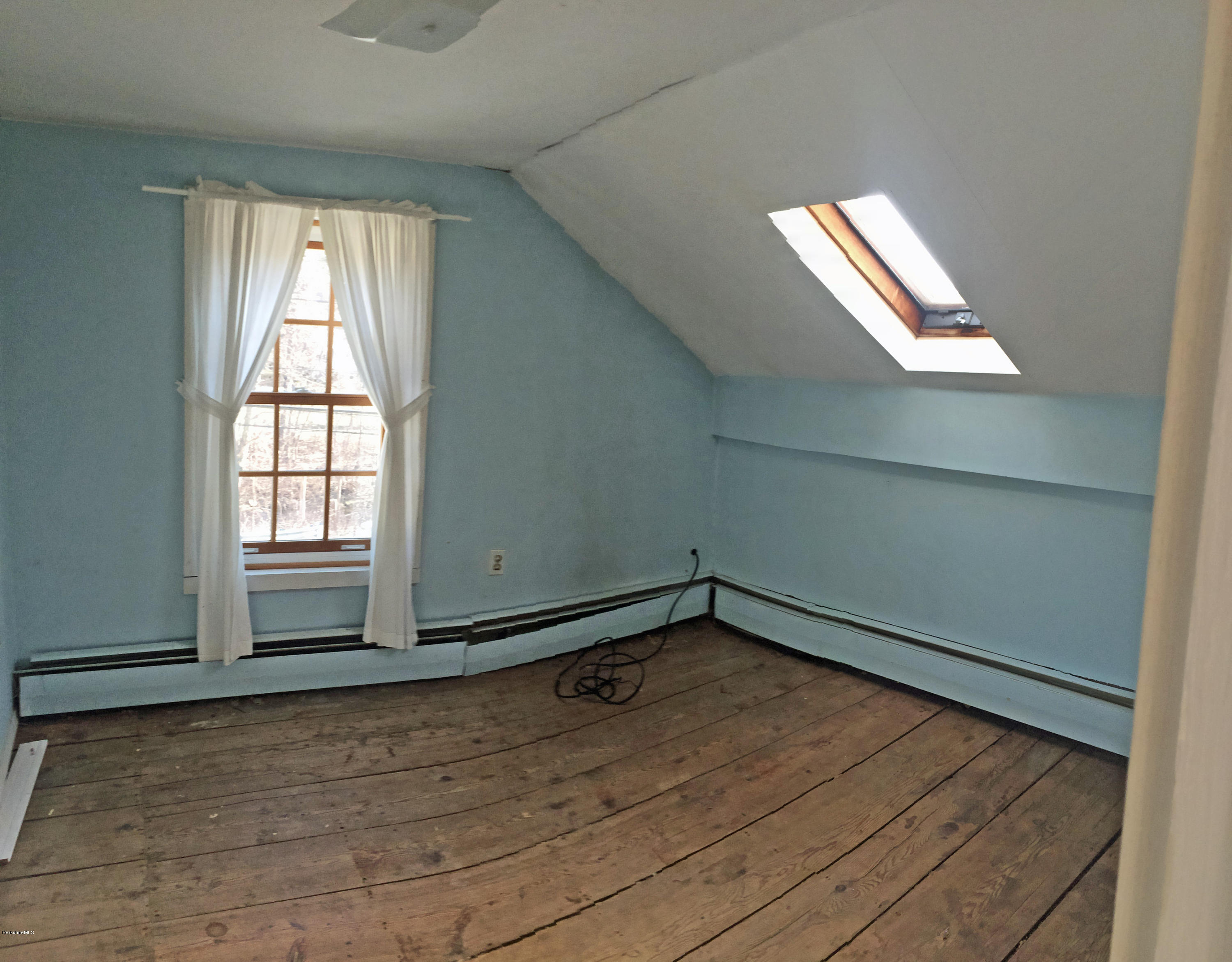55 Sandisfield Road Sandisfield, MA 01255 - Photo 19 of 20 a view of empty room with wooden floor and fan
