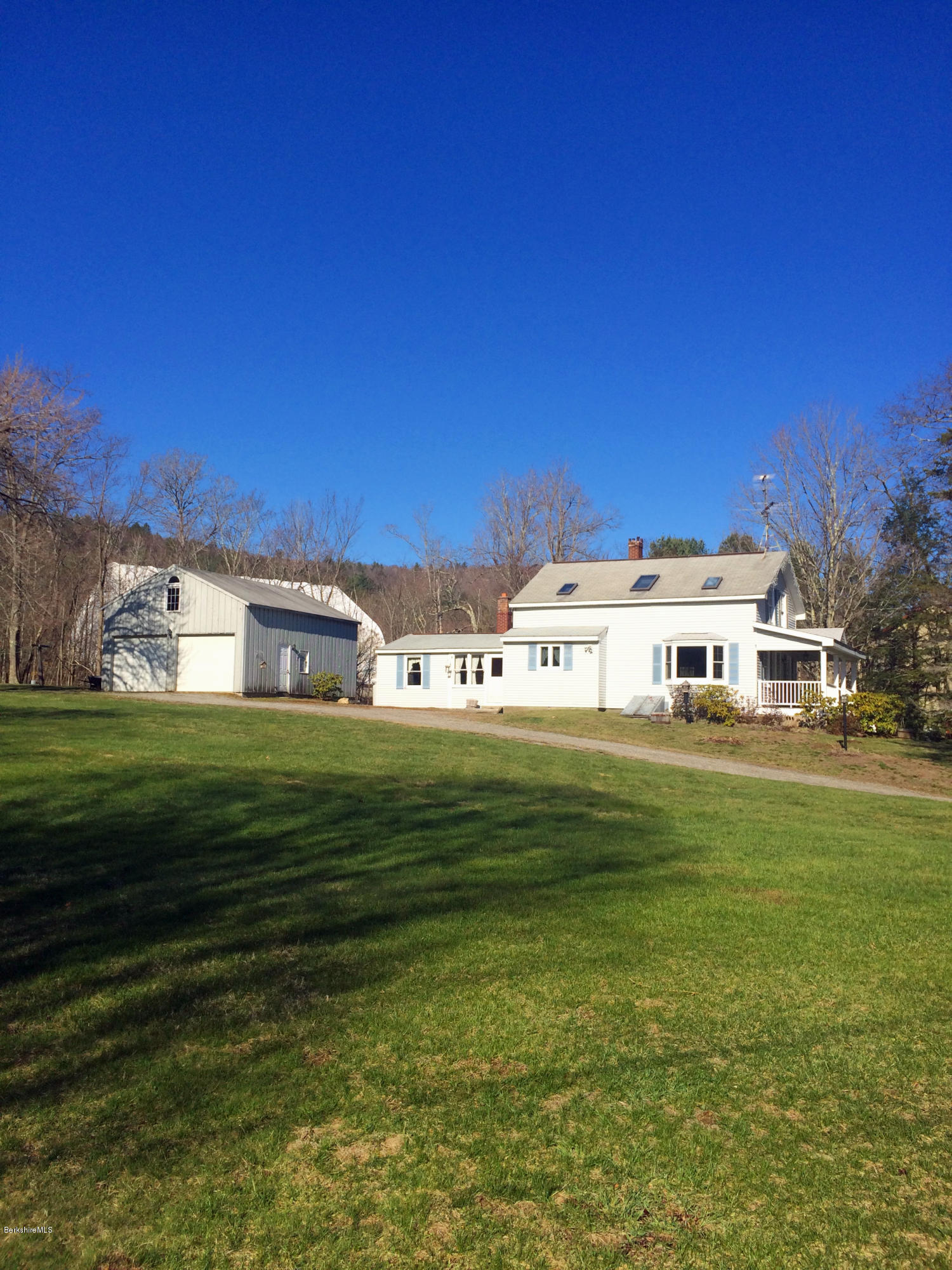 55 Sandisfield Road Sandisfield, MA 01255 - Photo 7 of 20 a view of a big yard with a house in the background