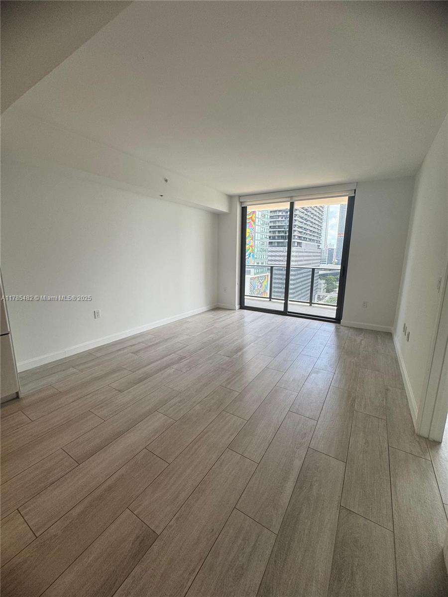 Brickell Miami, FL 33130 - Photo 12 of 12 wooden floor in an empty room with a window