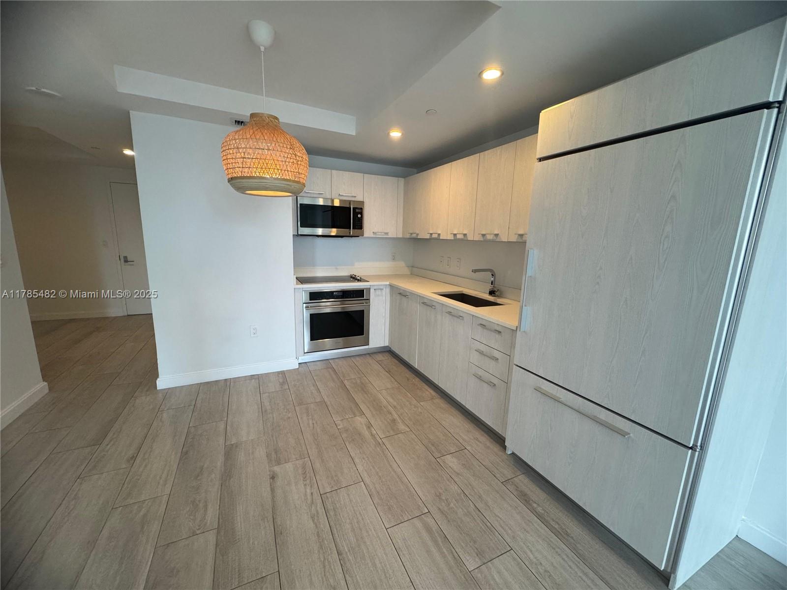 Brickell Miami, FL 33130 - Photo 2 of 12 a kitchen with stainless steel appliances a refrigerator sink and microwave
