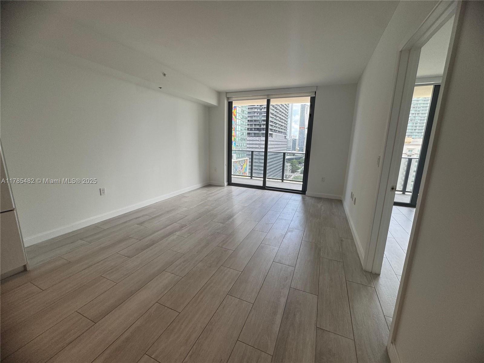 Brickell Miami, FL 33130 - Photo 4 of 12 an empty room with wooden floor and windows
