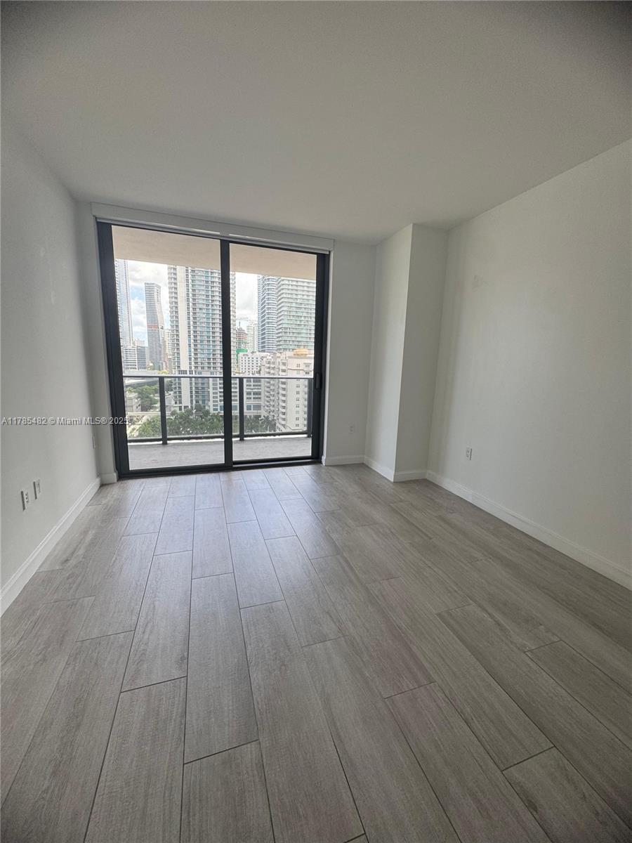 Brickell Miami, FL 33130 - Photo 6 of 12 wooden floor in an empty room with a window