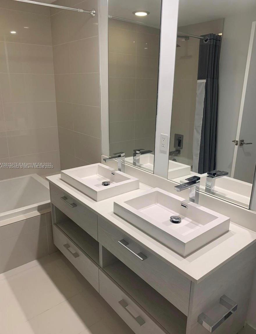 Brickell Miami, FL 33130 - Photo 7 of 12 a bathroom with a sink and a mirror