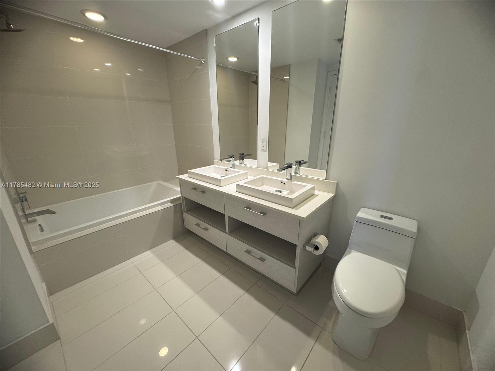 Brickell Miami, FL 33130 - Photo 9 of 12 a bathroom with a sink a toilet and a bathtub