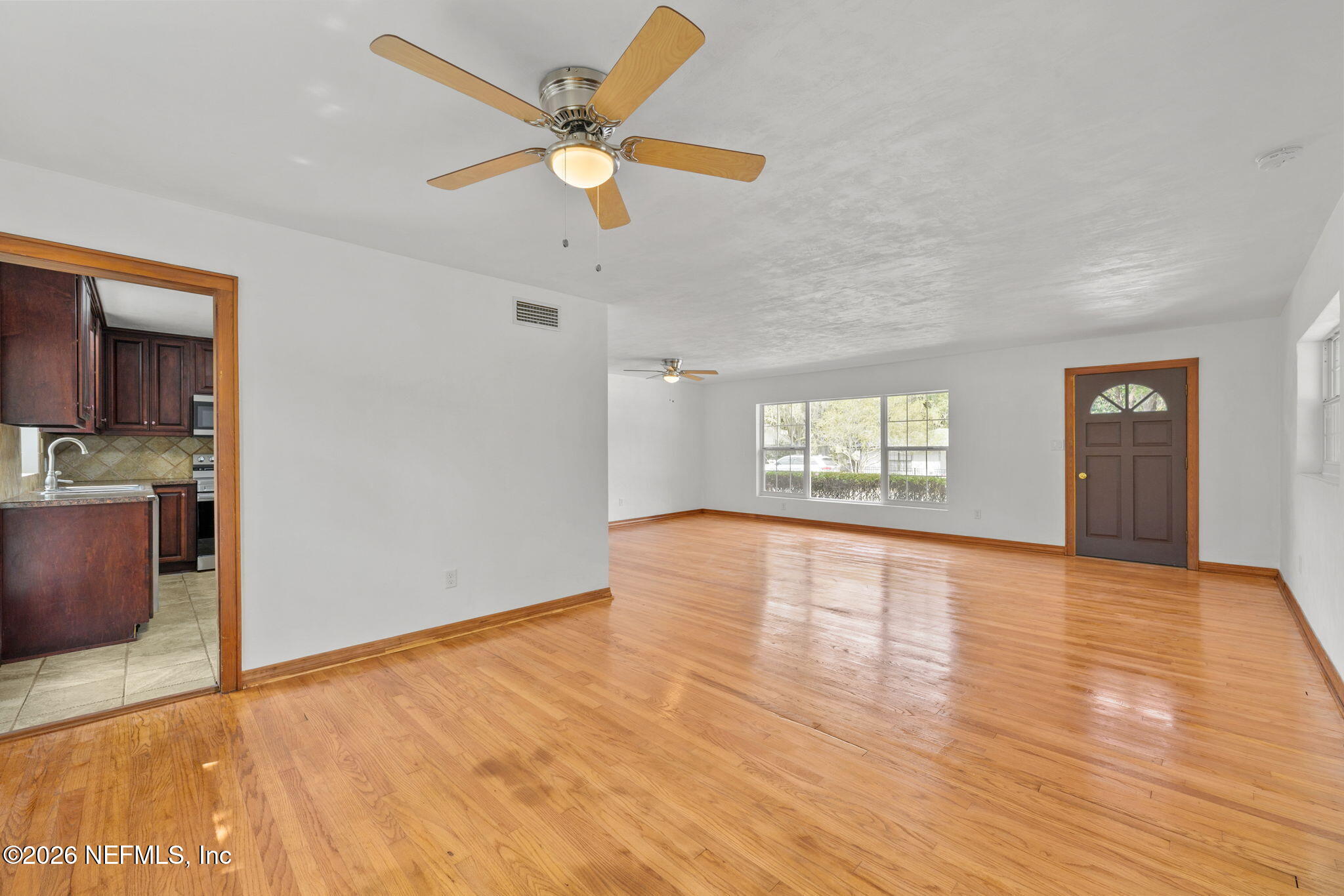 2003 Laurel Street Palatka, FL 32177 - Photo 6 of 31 a view of an empty room with window and wooden floor