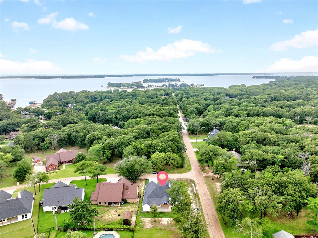 120 Springwood Road Enchanted Oaks, TX 75156 - Photo 35 of 37 Waterfront community featuring abundant mature trees and a residential street