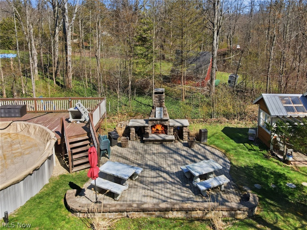 8965 Cedar Road Chesterland, OH 44026 - Photo 40 of 50 Paver Patio with Outdoor Fireplace Next to the Above Ground Pool