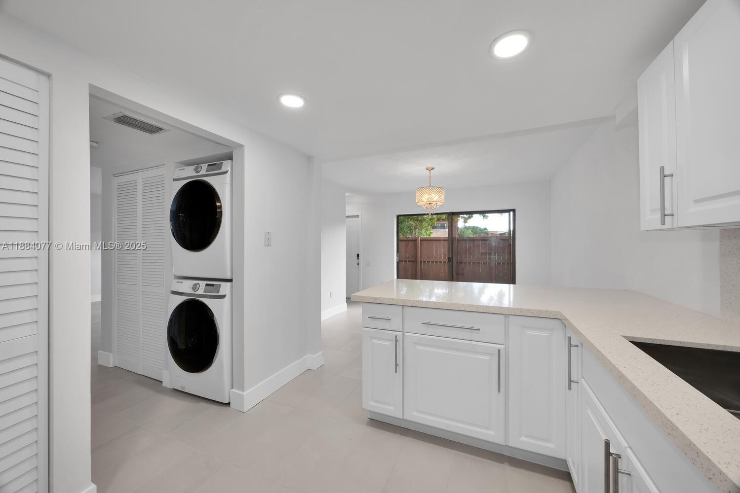 11500 Southwest 64th Street, Unit H Miami, FL 33173 - Photo 12 of 38 a view of a kitchen with washer and dryer