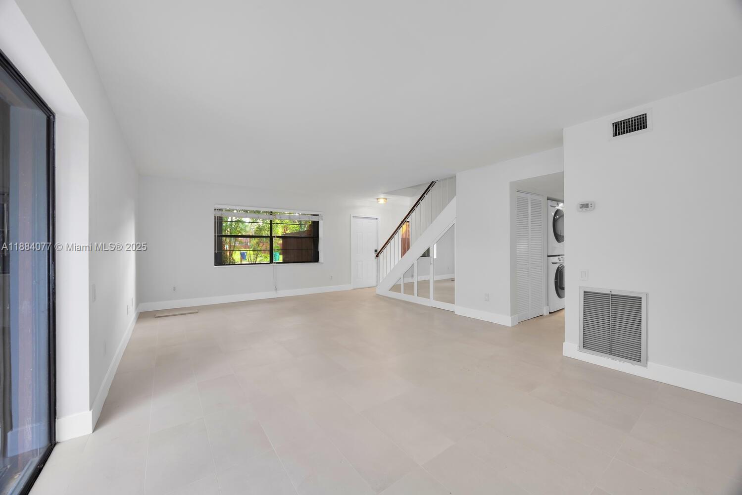 11500 Southwest 64th Street, Unit H Miami, FL 33173 - Photo 18 of 38 an empty room with windows