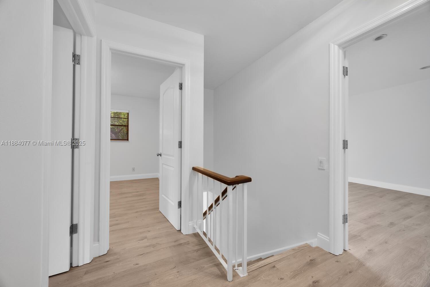 11500 Southwest 64th Street, Unit H Miami, FL 33173 - Photo 21 of 38 a view of a hallway with a door and wooden floor