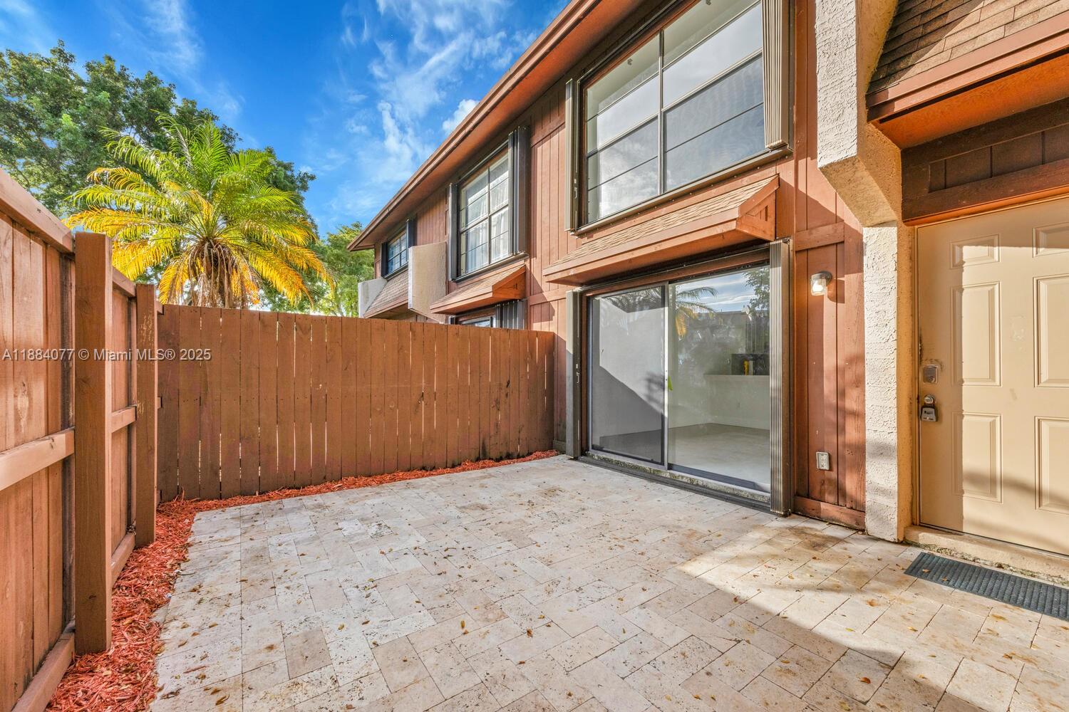 11500 Southwest 64th Street, Unit H Miami, FL 33173 - Photo 3 of 38 a view of a house with a tree