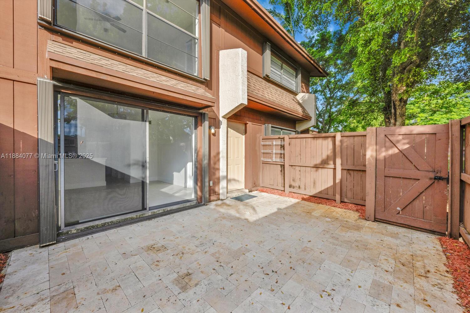 11500 Southwest 64th Street, Unit H Miami, FL 33173 - Photo 4 of 38 a view of a house with a outdoor space