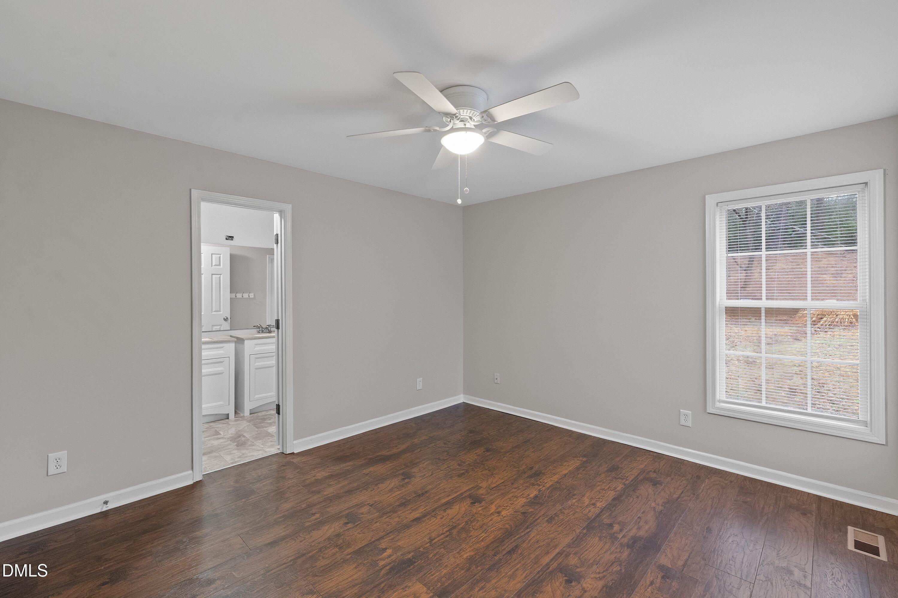 140 Melksham Road Wake Forest, NC 27587 - Photo 20 of 34 an empty room with wooden floor closet and windows