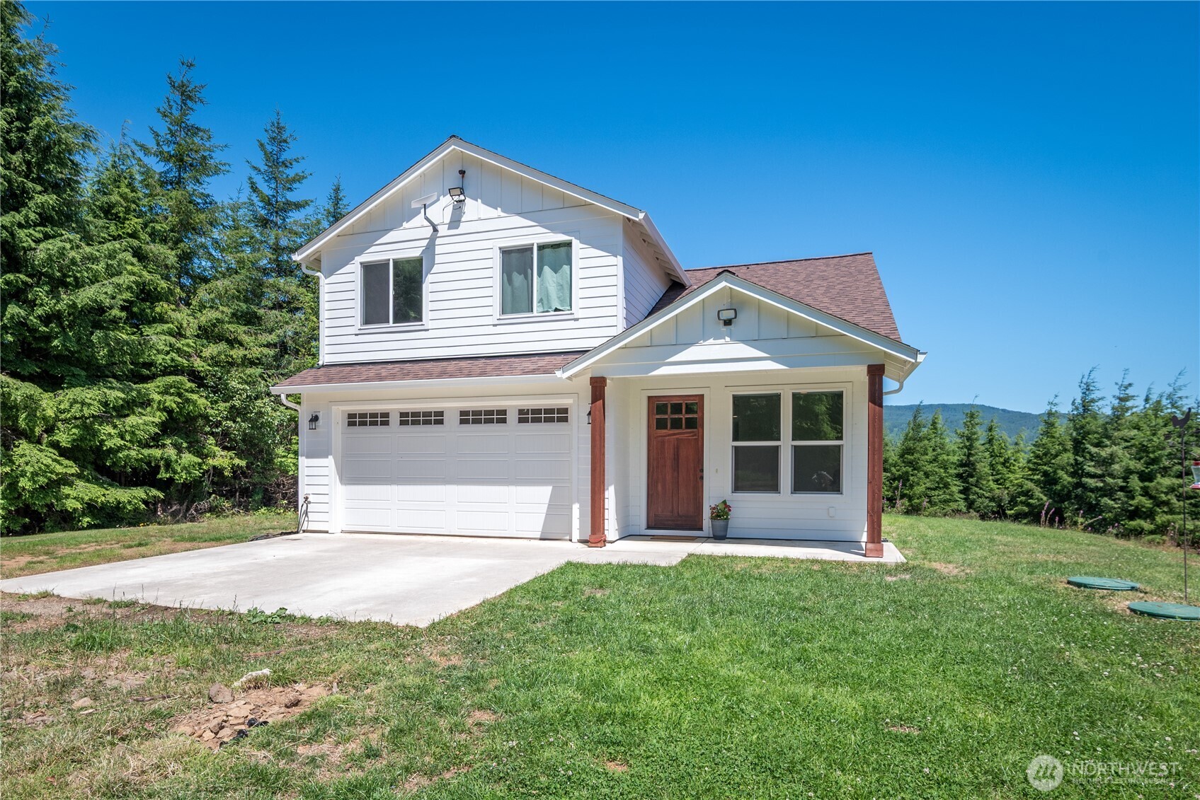 327 Parpala Road Naselle, WA 98638 - Photo 1 of 36 a front view of a house with a yard and garage