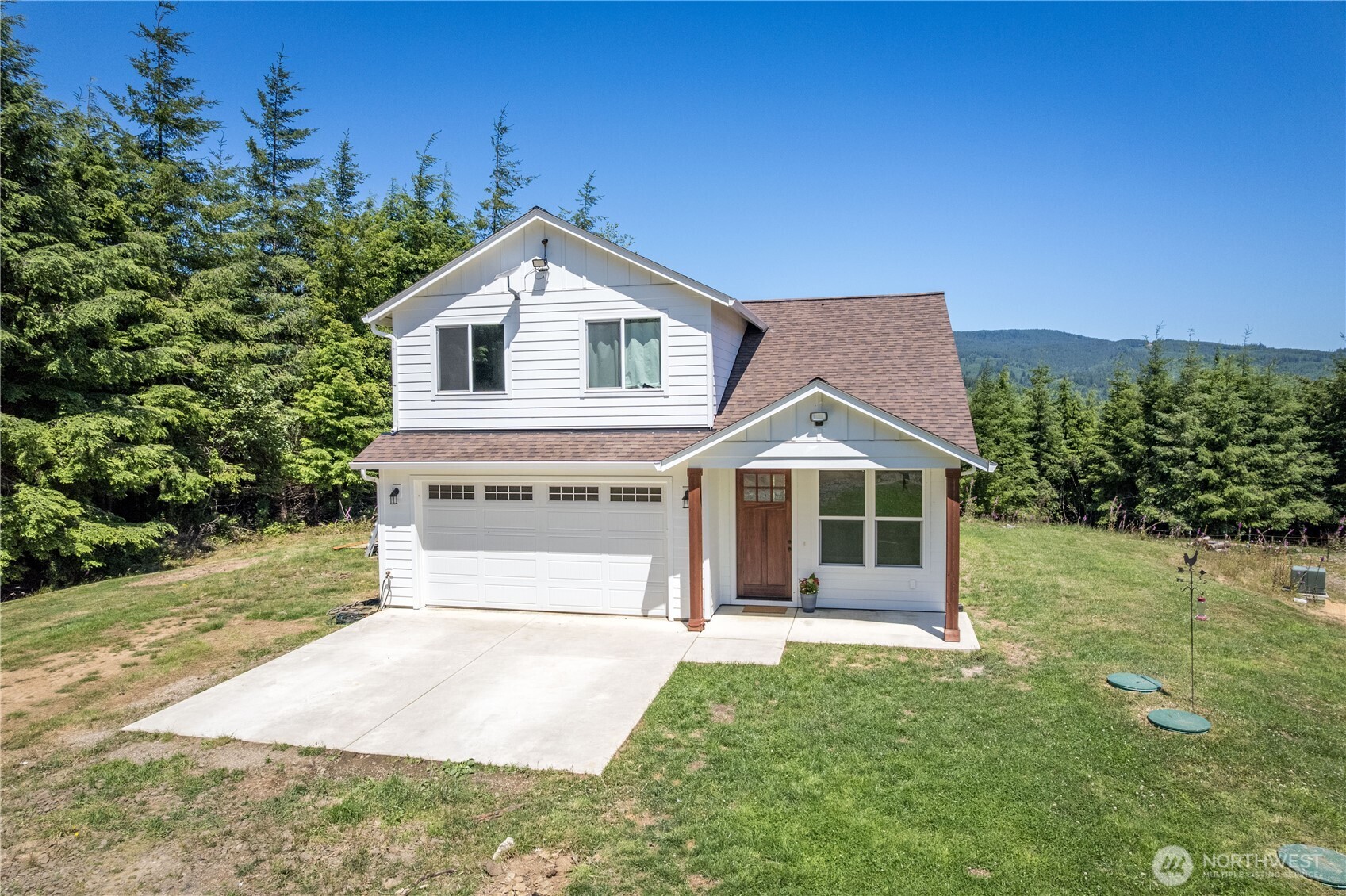 327 Parpala Road Naselle, WA 98638 - Photo 34 of 38 a front view of a house with a yard and garage