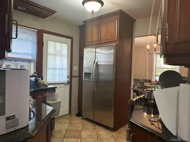 a kitchen with a refrigerator and a stove