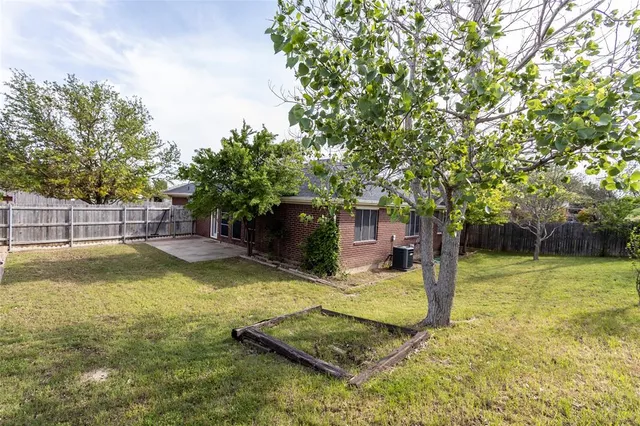 a view of a backyard with swimming pool