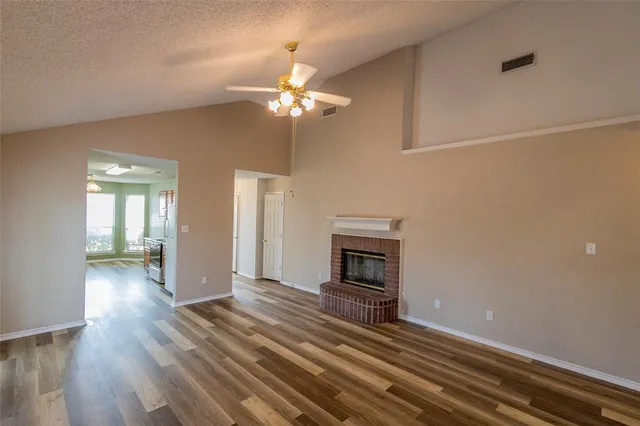 wooden floor in an empty room with a fireplace